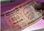 Rupee hits record low of 56.87 against dollar